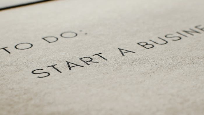 A focused image of a to-do list featuring 'Start a Business' on paper.
